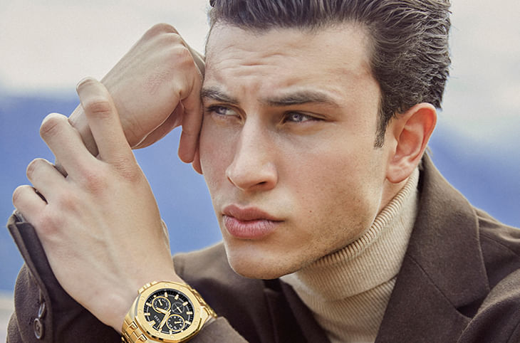 Un hombre moderno y audaz compra relojes Guess de oro y plata para impactar a sus amigos